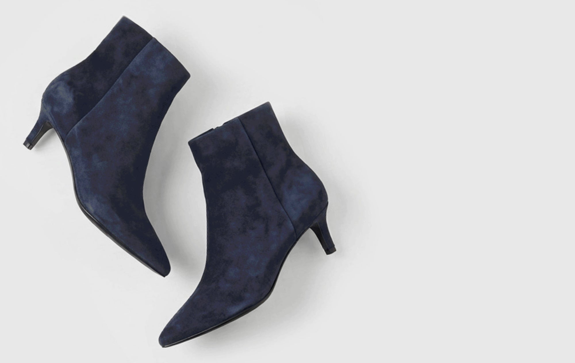 Editorial banner featuring navy suede styles